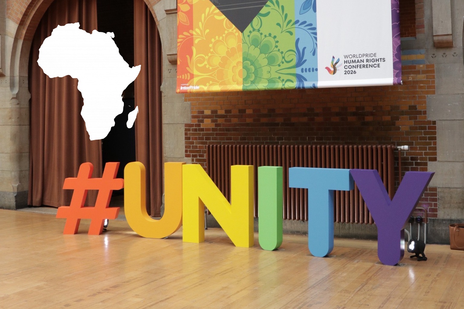 WorldPride Human Rights Conference 2026 venue in Amsterdam with the UNITY installation and an Africa map overlay